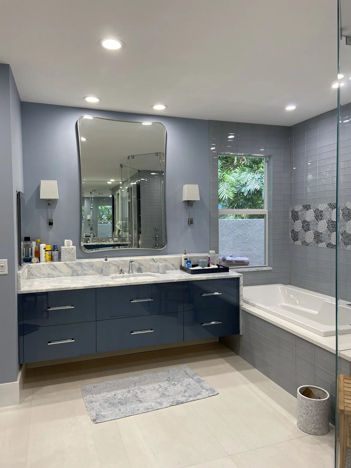Dual vanity, marble countertop, and custom cabinetry.